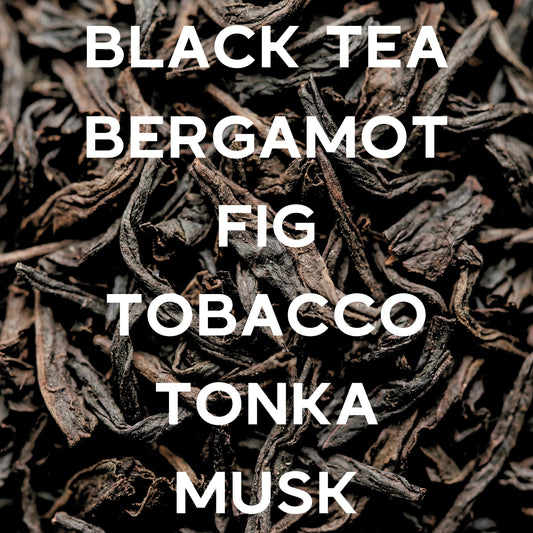 Black tea leaves with text describing notes on a black background