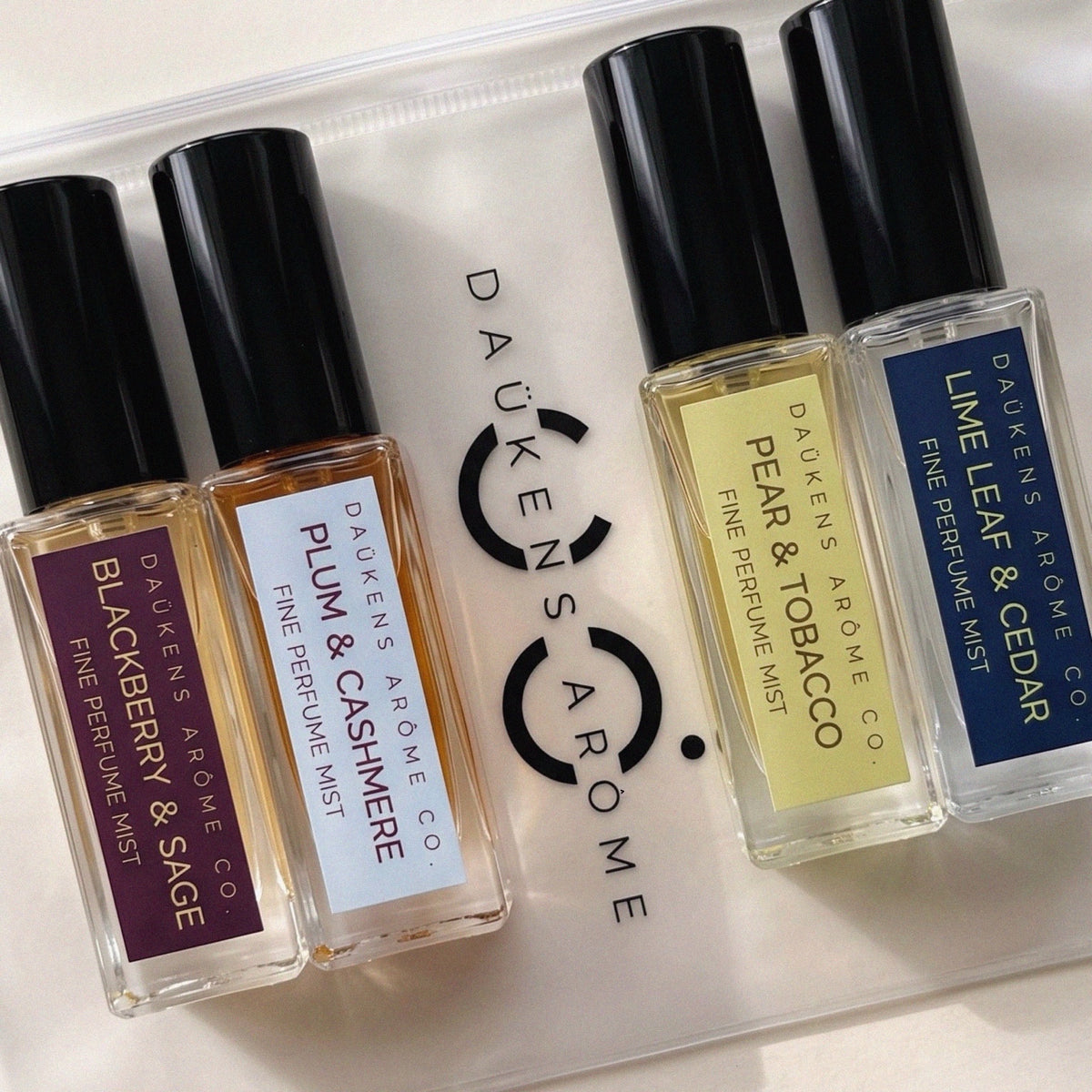 Four Fine Perfume Mist Discovery Set bottles on the branded Daukens Arome pouch.