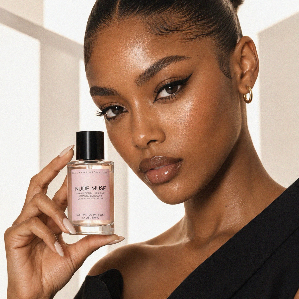 Woman holding Nude Muse Extrait de Parfum